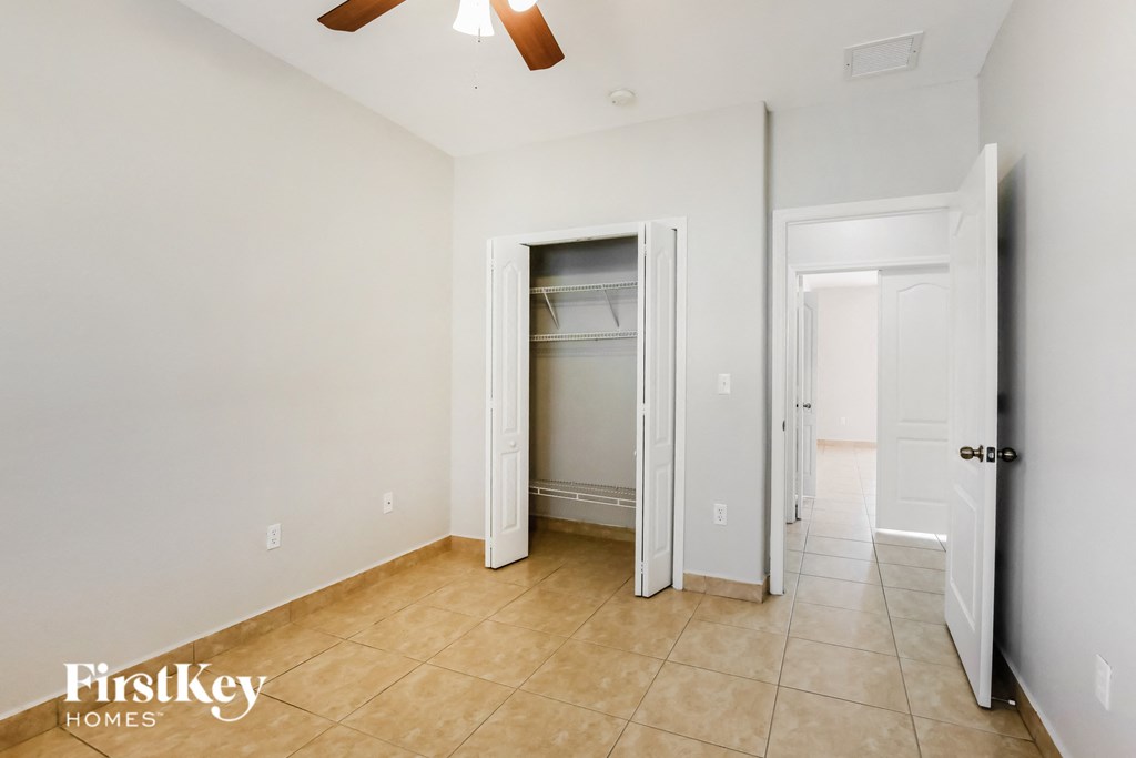 the master bedroom has a large closet and a tile floor