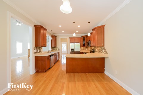 A well-lit kitchen with wooden cabinets and a central island.