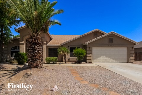 a house with a palm tree in front of it