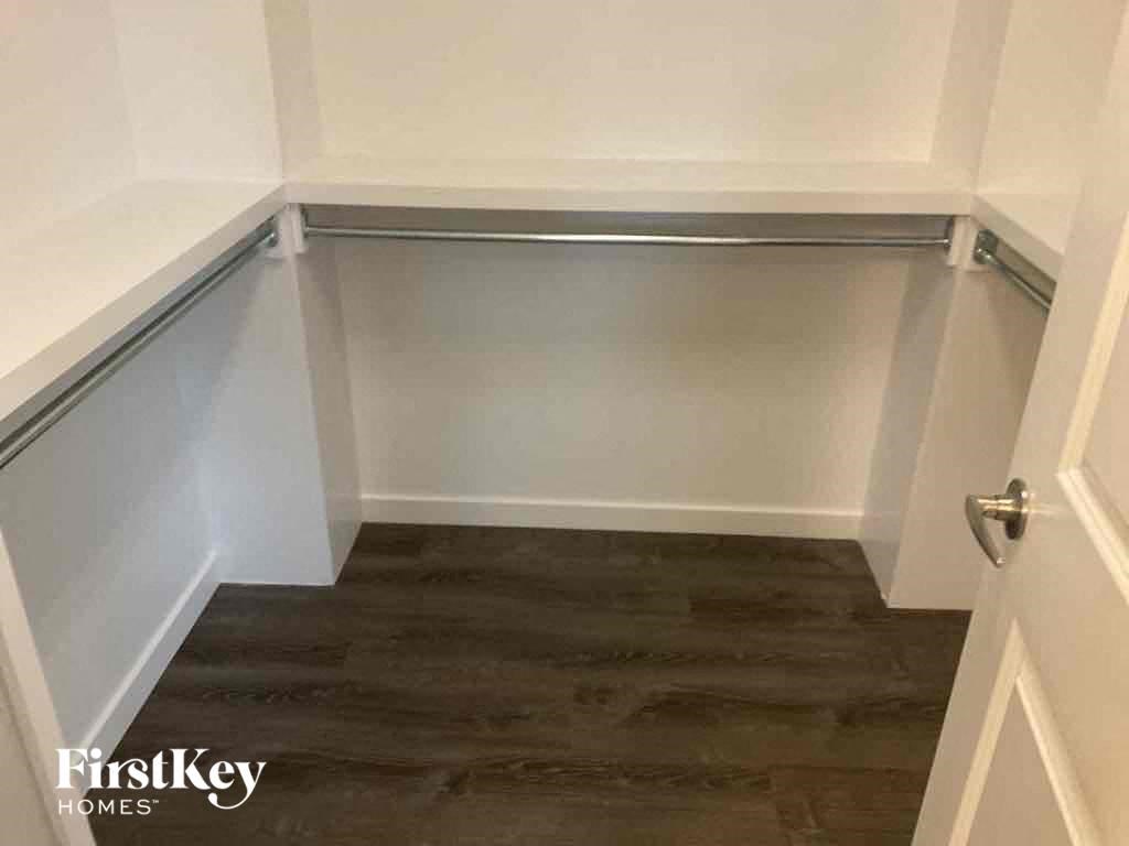 a small room with a wooden floor and white walls