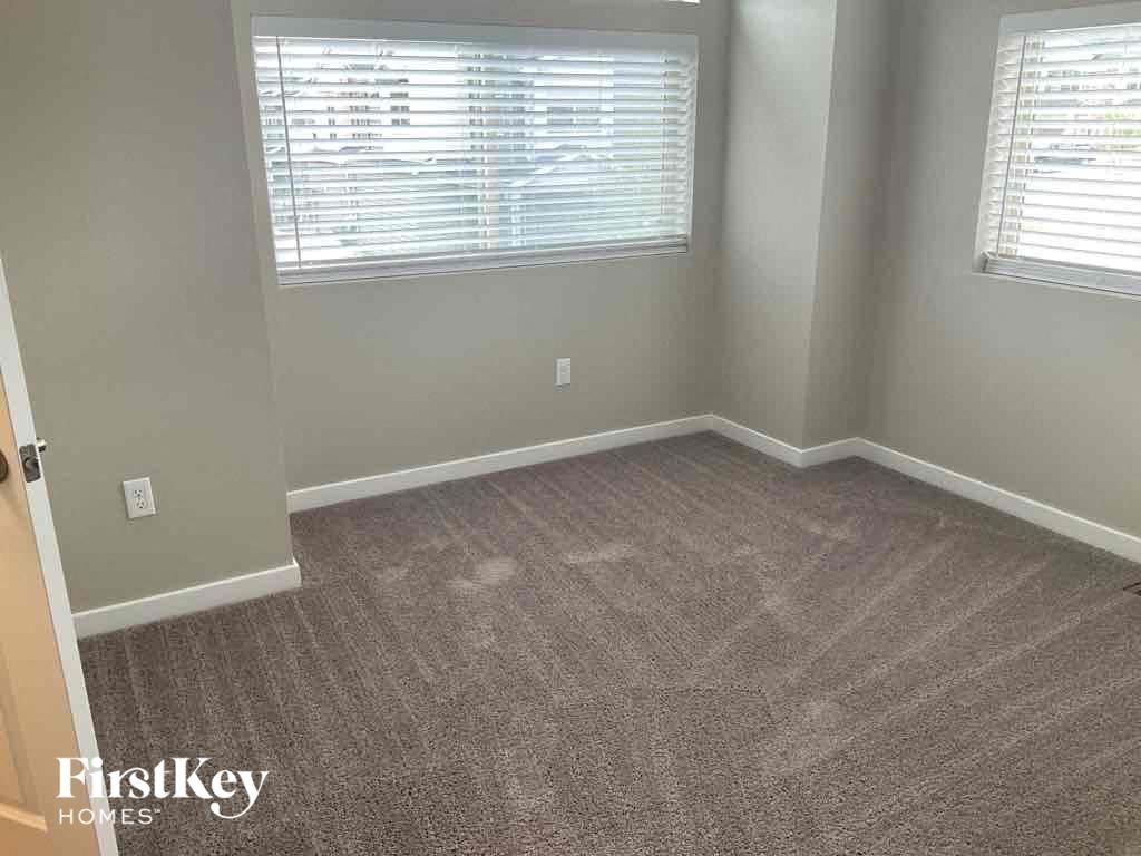 an empty room with carpet and a window
