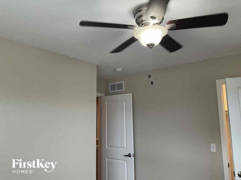 a ceiling fan with a light on it in a room