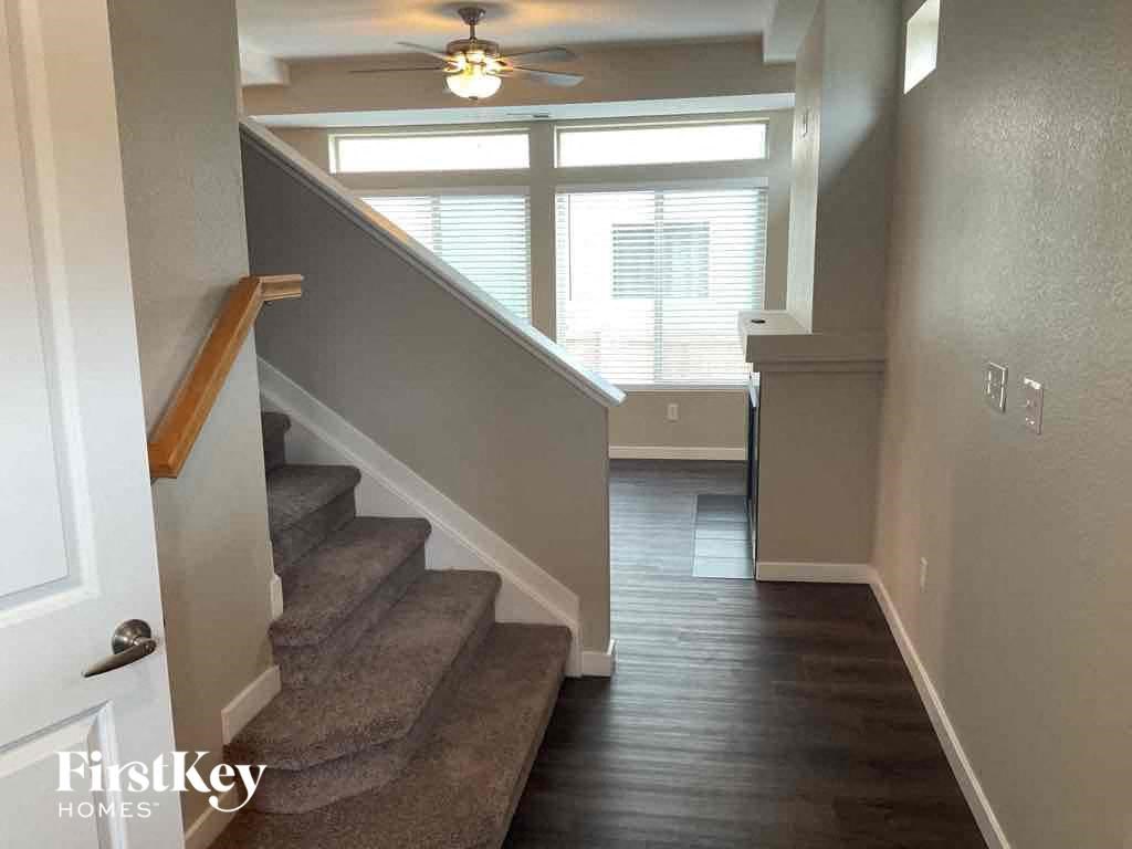 a staircase in a home with a ceiling fan