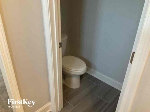a small bathroom with a white toilet in it