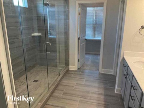 a bathroom with a glass shower and a sink