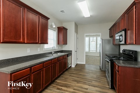 a kitchen with wooden cabinets and stainless steel appliances