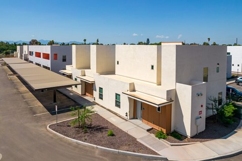A modern building with a parking lot in front.