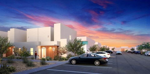 A modern building with a parking lot in front of it.