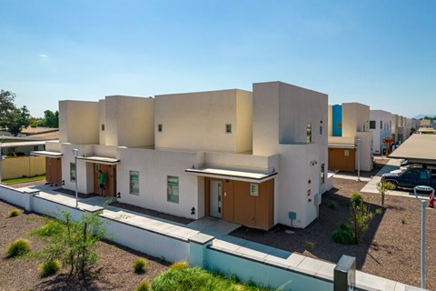 A modern building with white walls and brown doors.