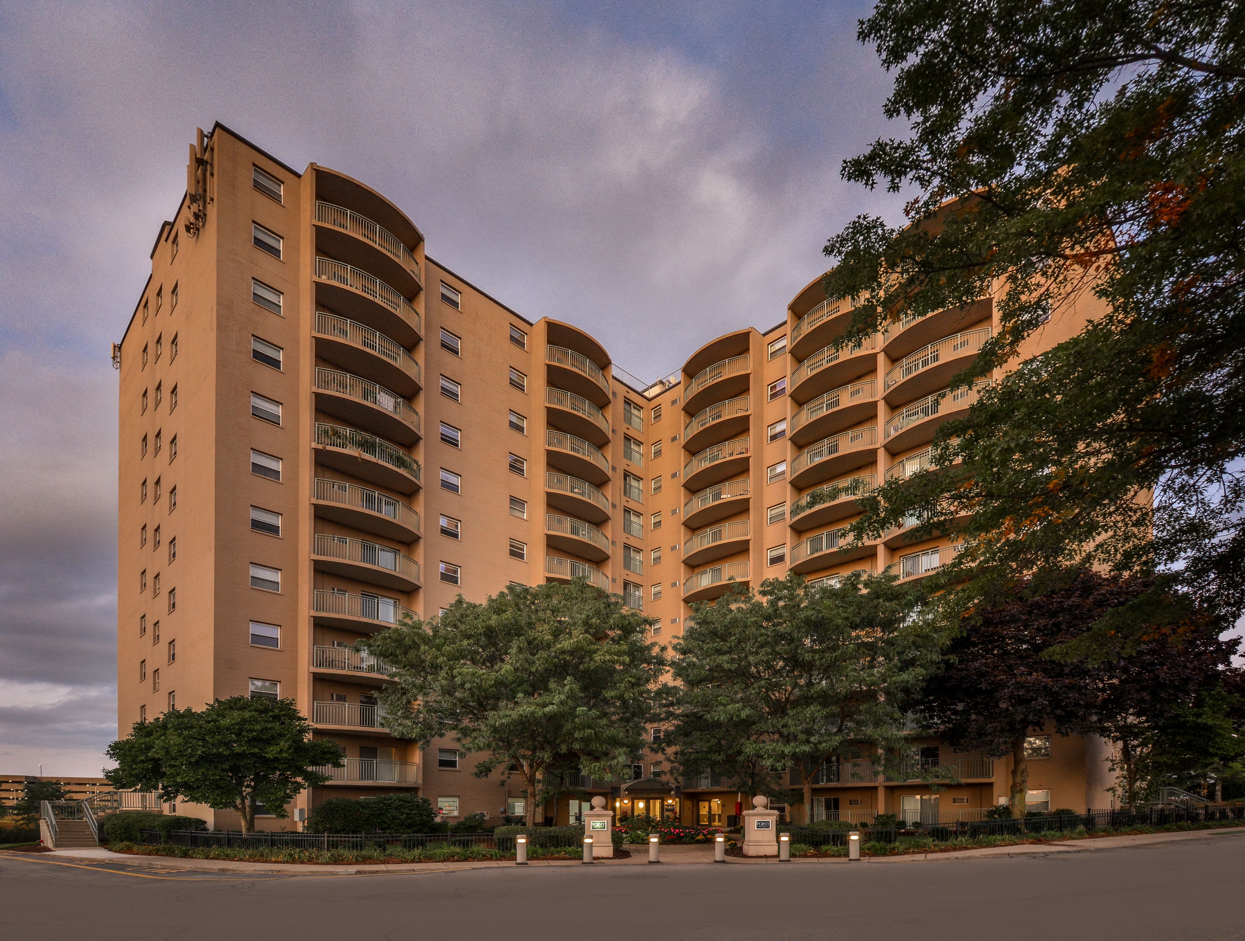 a large apartment building with trees in front of it