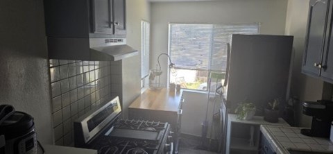 A kitchen with a stove top oven and a microwave.