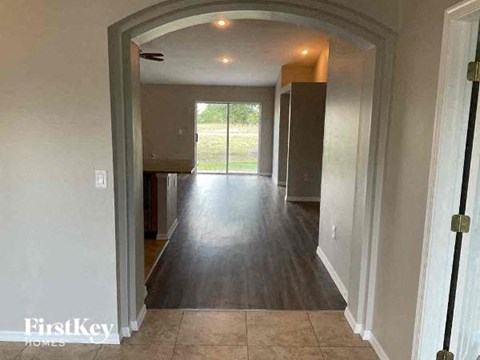a hallway of a house with a hard wood floor