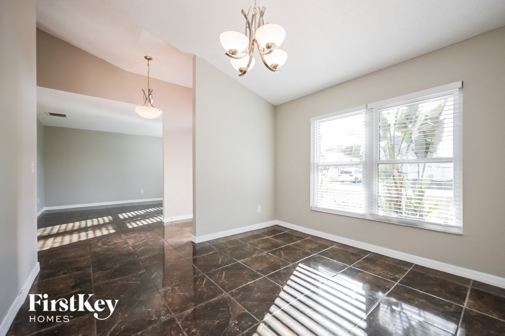 the living room and dining room of an empty house