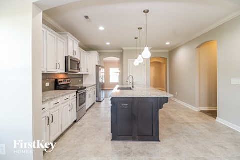 A kitchen with a black island in the middle of it.
