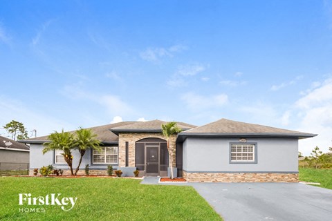 a house with palm trees in front of it