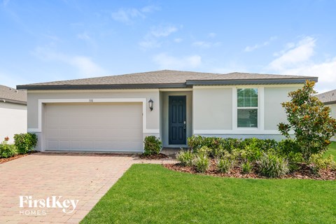 A house with a garage door and a blue door is shown.