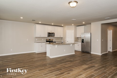 A kitchen with wooden floors and white walls.