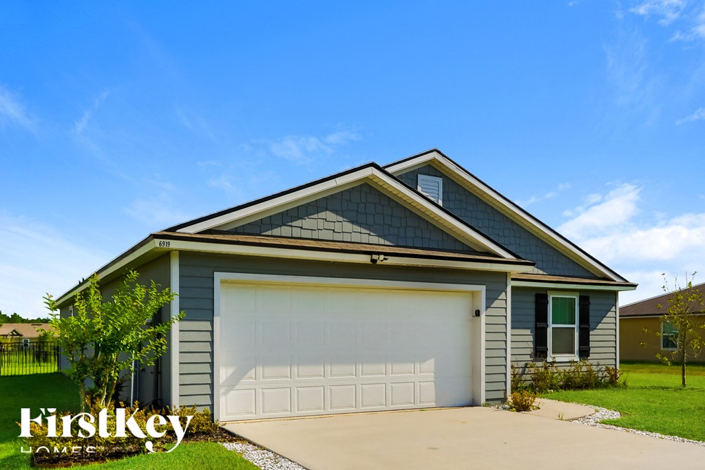 a garage with a white door in front of a house