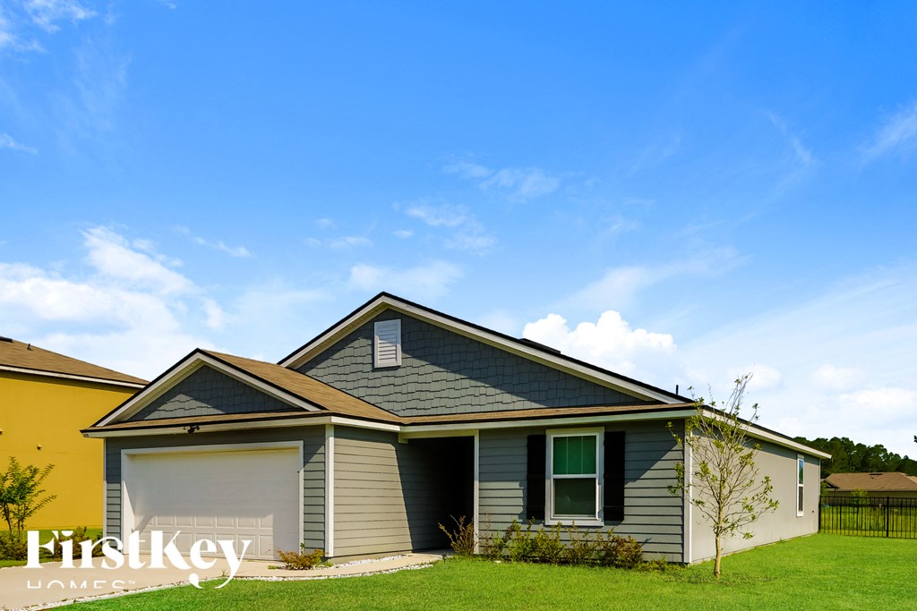 a house with a garage and a blue sky