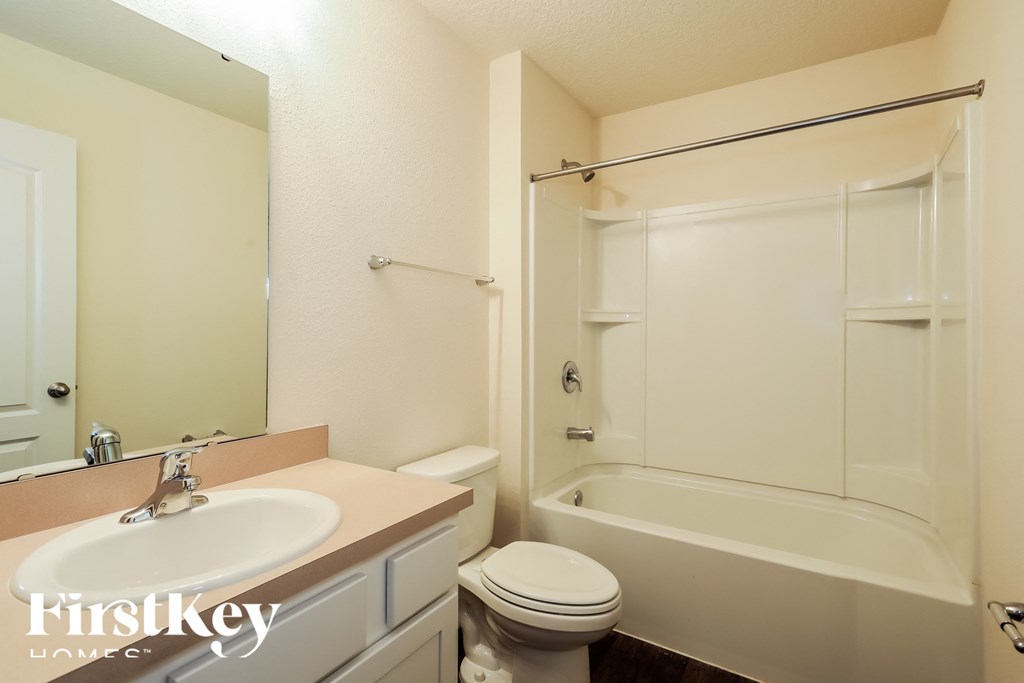 a bathroom with a sink toilet and a shower