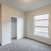 an empty room with a window and a door