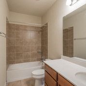 a bathroom with a toilet and a sink and a shower