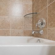 a bathroom with a bath tub and a sink