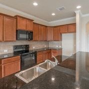 a kitchen with granite counter tops and a sink