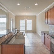 an empty kitchen with a sink and a window