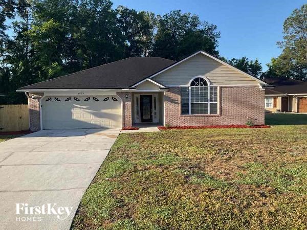 A brick house with a garage is for sale.