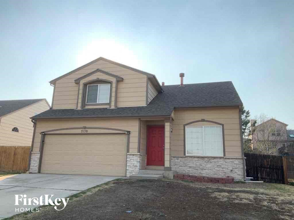 a house with a garage and a red door