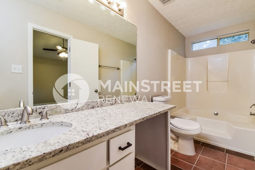 a bathroom with a sink and a toilet and a tub