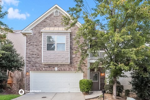 a brick house with a white garage door