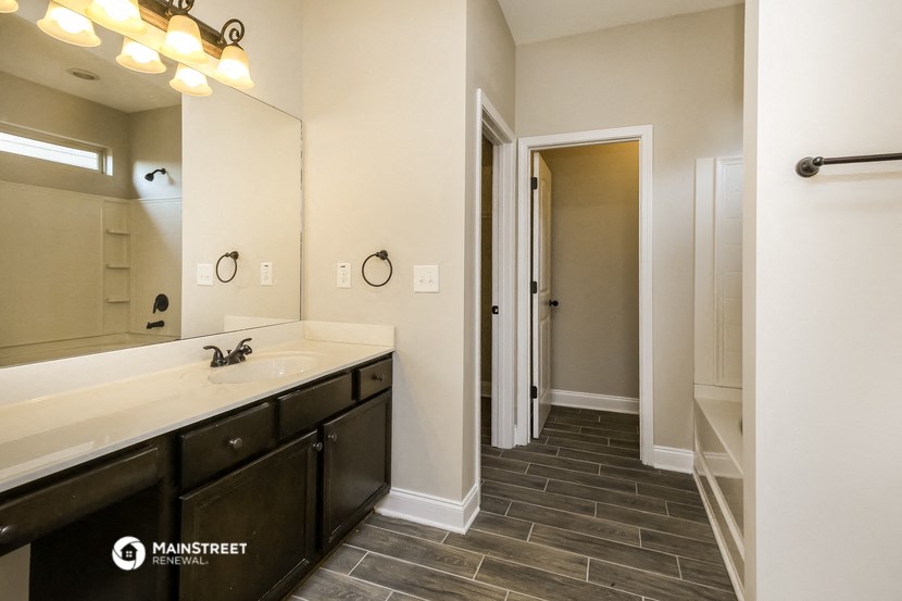 a bathroom with a large mirror and a sink