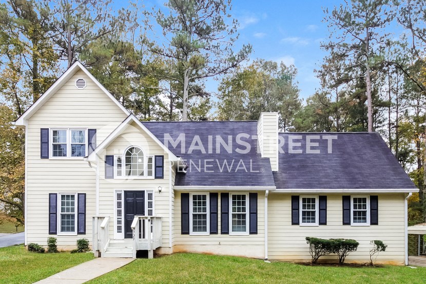 a white house with the feet newwall on the side