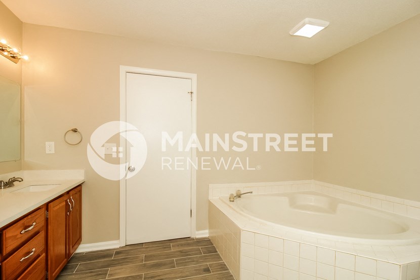 a bathroom with a large jacuzzi tub and a sink