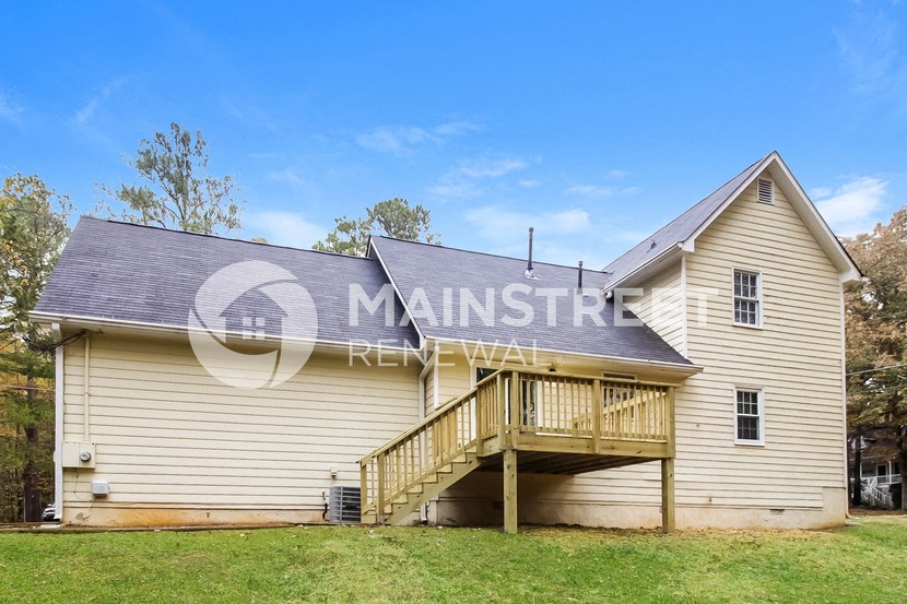 side view of a house with a porch and a deck