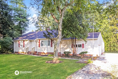 a white and with a tree in the front