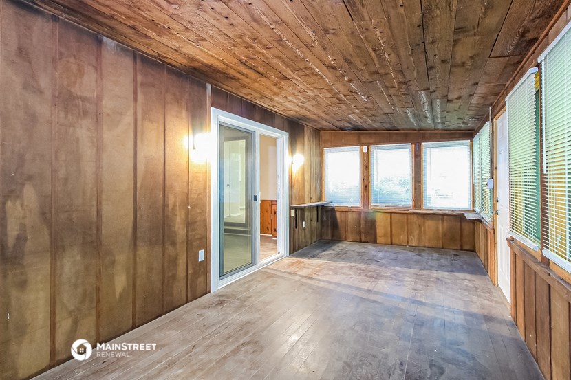 a room with wooden walls and a sliding glass door