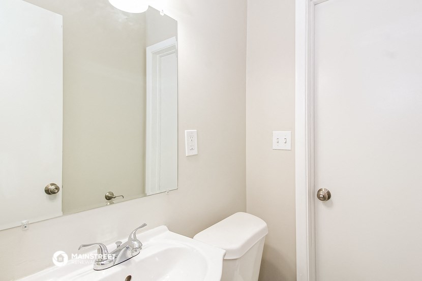 a bathroom with a sink and a mirror and a toilet