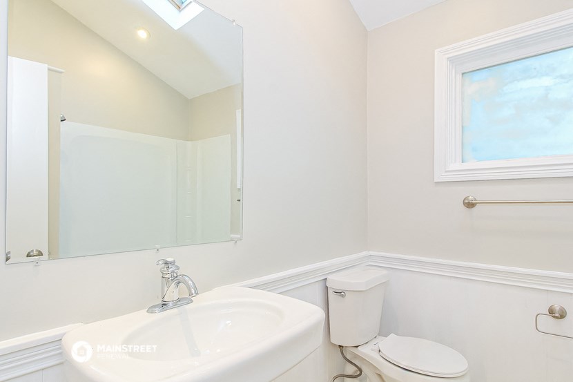a bathroom with a sink and a toilet and a mirror