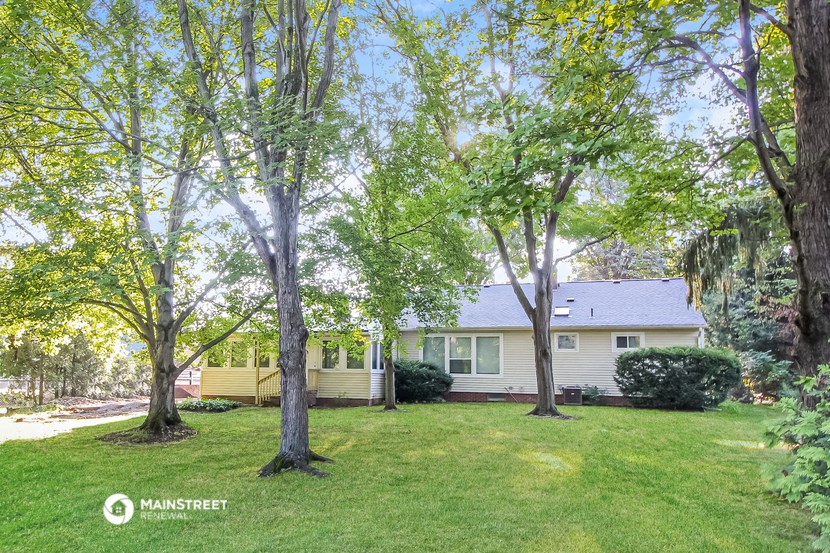 a white house with trees in front of it