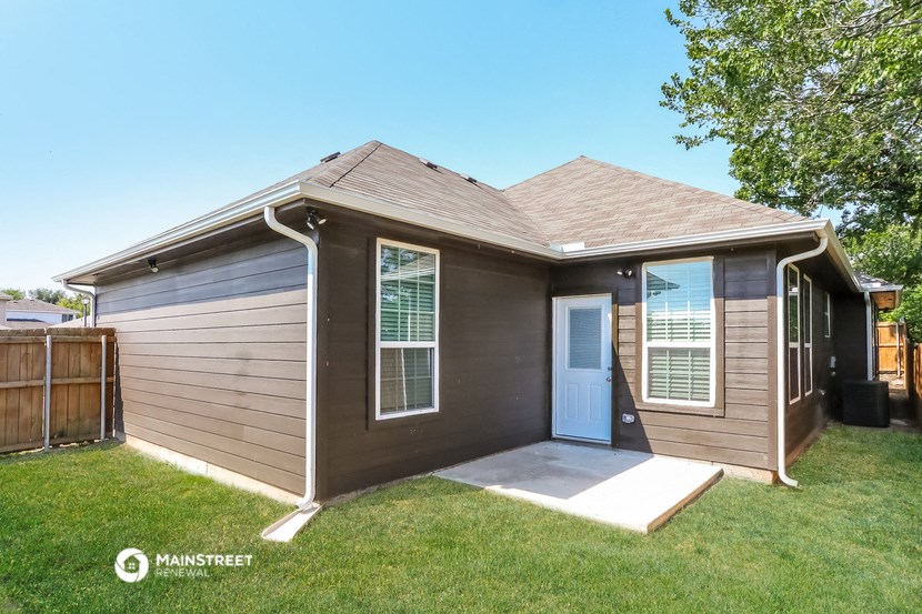 the front of a house with a porch and a door