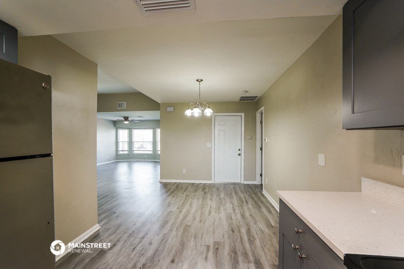 an empty kitchen and living room with hardwood flooring