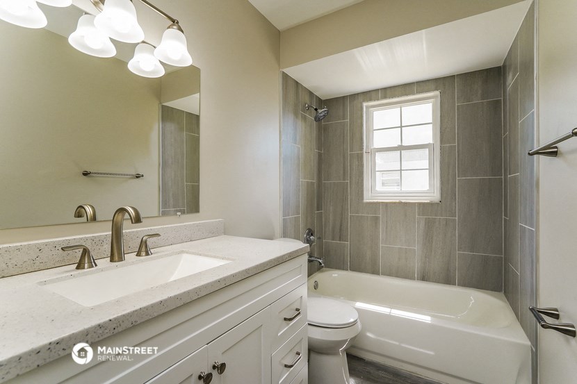 a bathroom with a sink and a toilet and a tub
