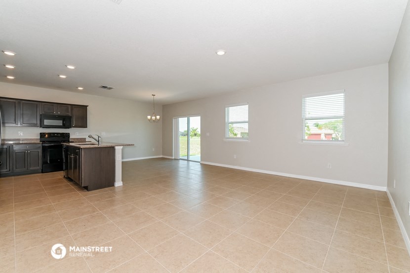 the kitchen and living room are spacious and clean