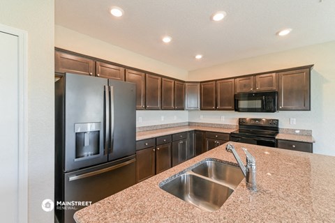 a kitchen with stainless steel appliances and granite counter tops