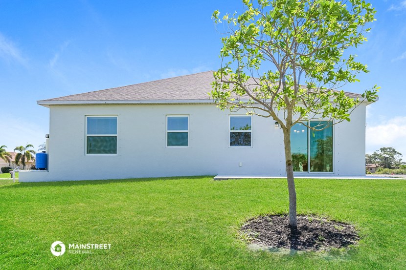 a white house with a tree in front of it