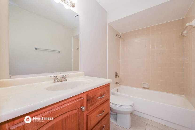 a bathroom with a sink and a toilet and a tub