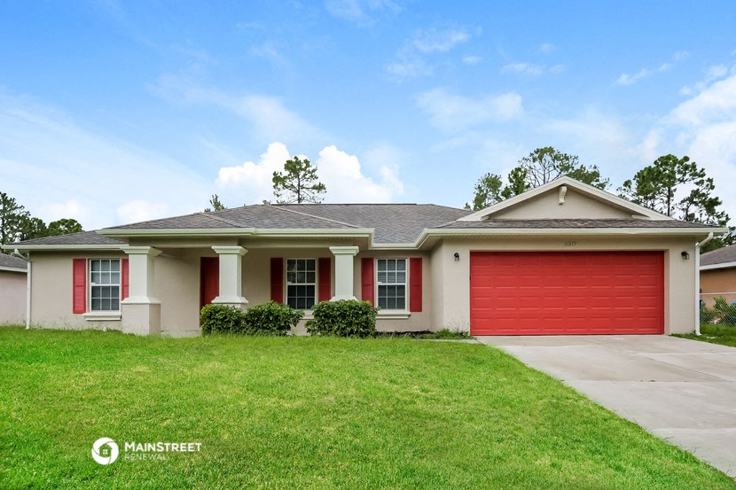 a house with a red garage door and a lawn